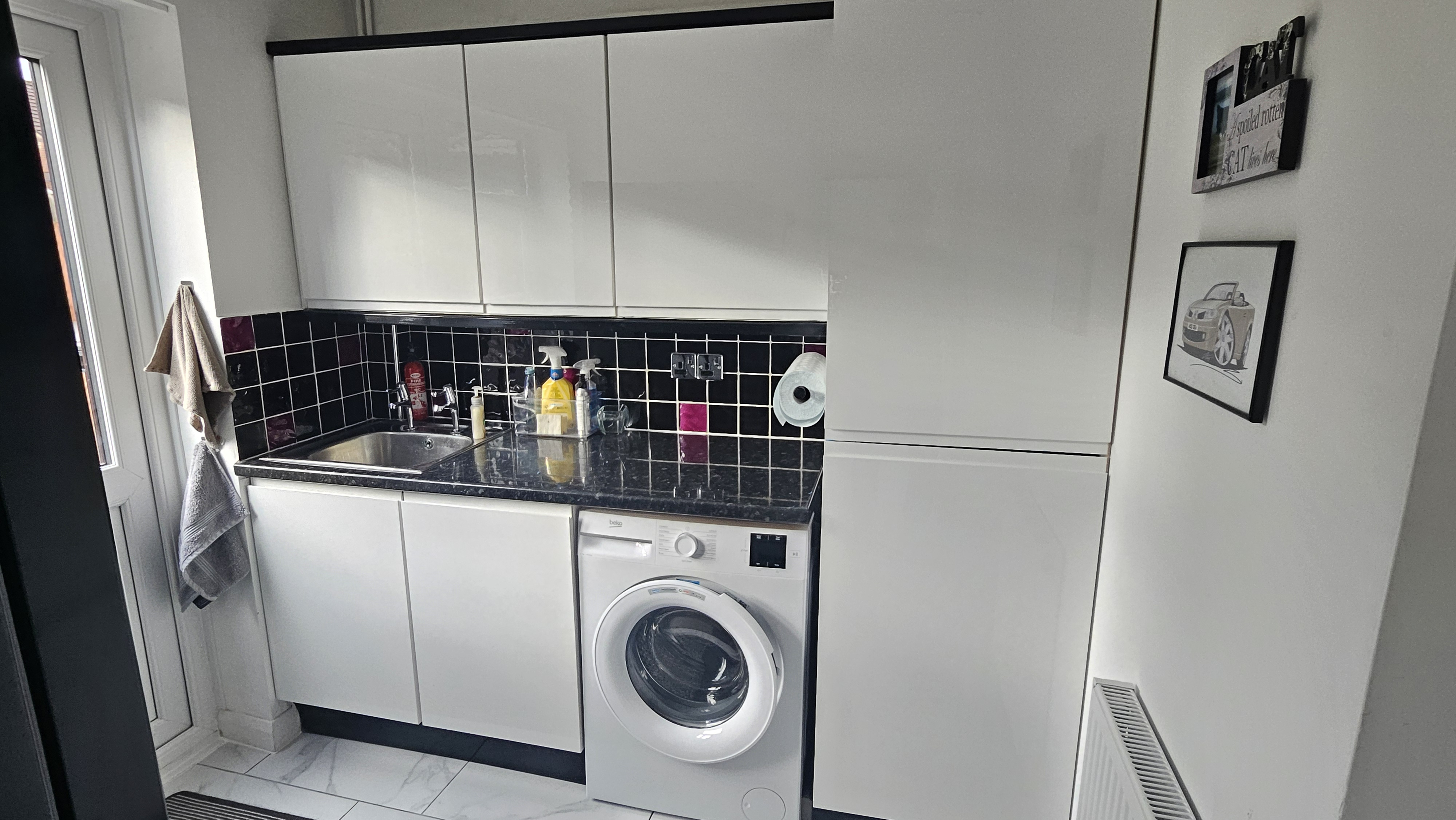 Real customer utility room with supergloss white Jayline handleless kitchen doors in a sleek modern design