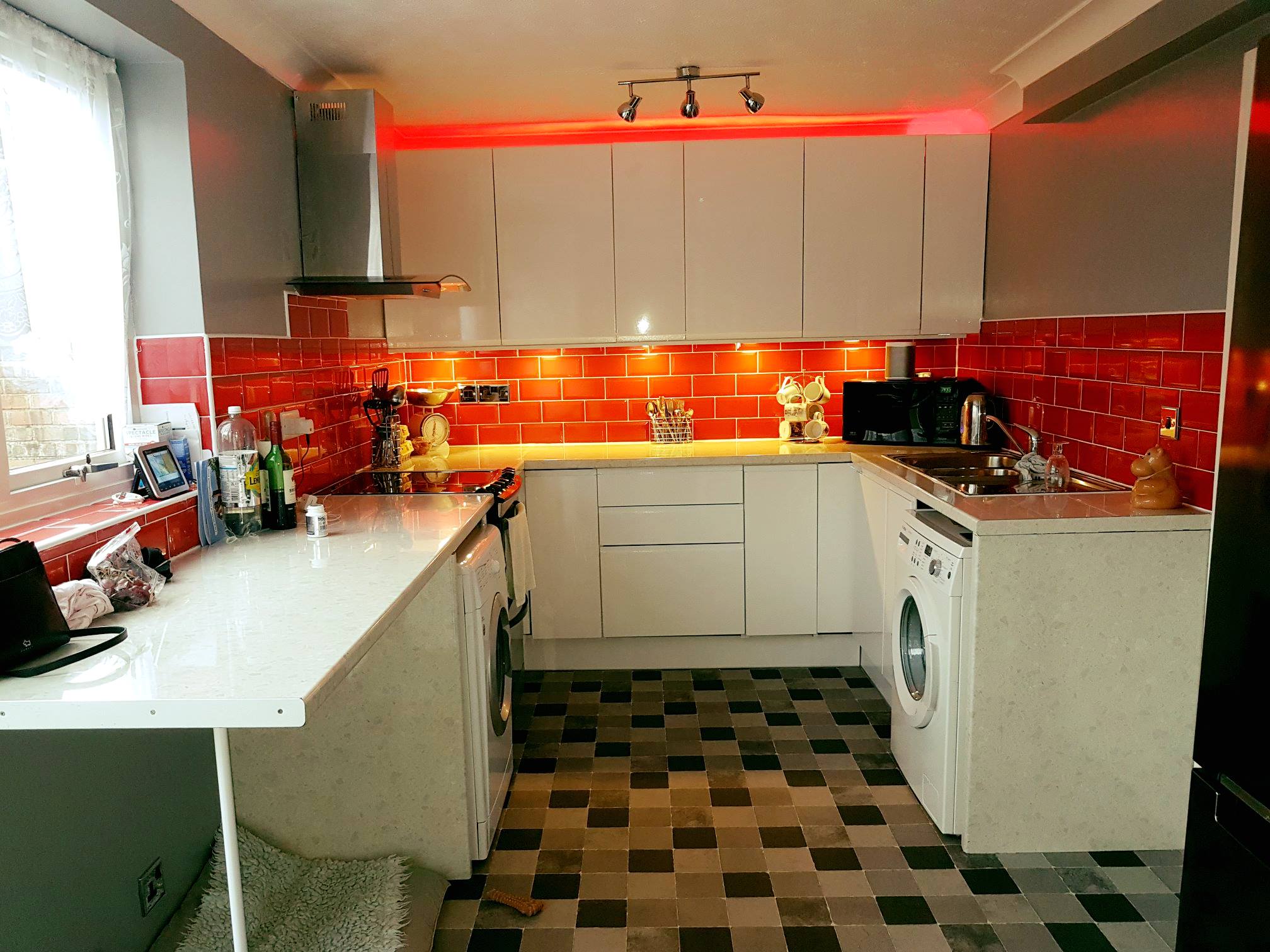 Real customer kitchen with high gloss white handleless kitchen doors in a sleek modern design