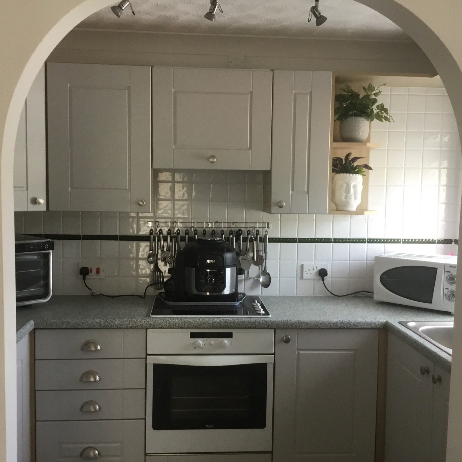 Real customer kitchen with matt dove grey Surrey kitchen doors in a classic shaker style design