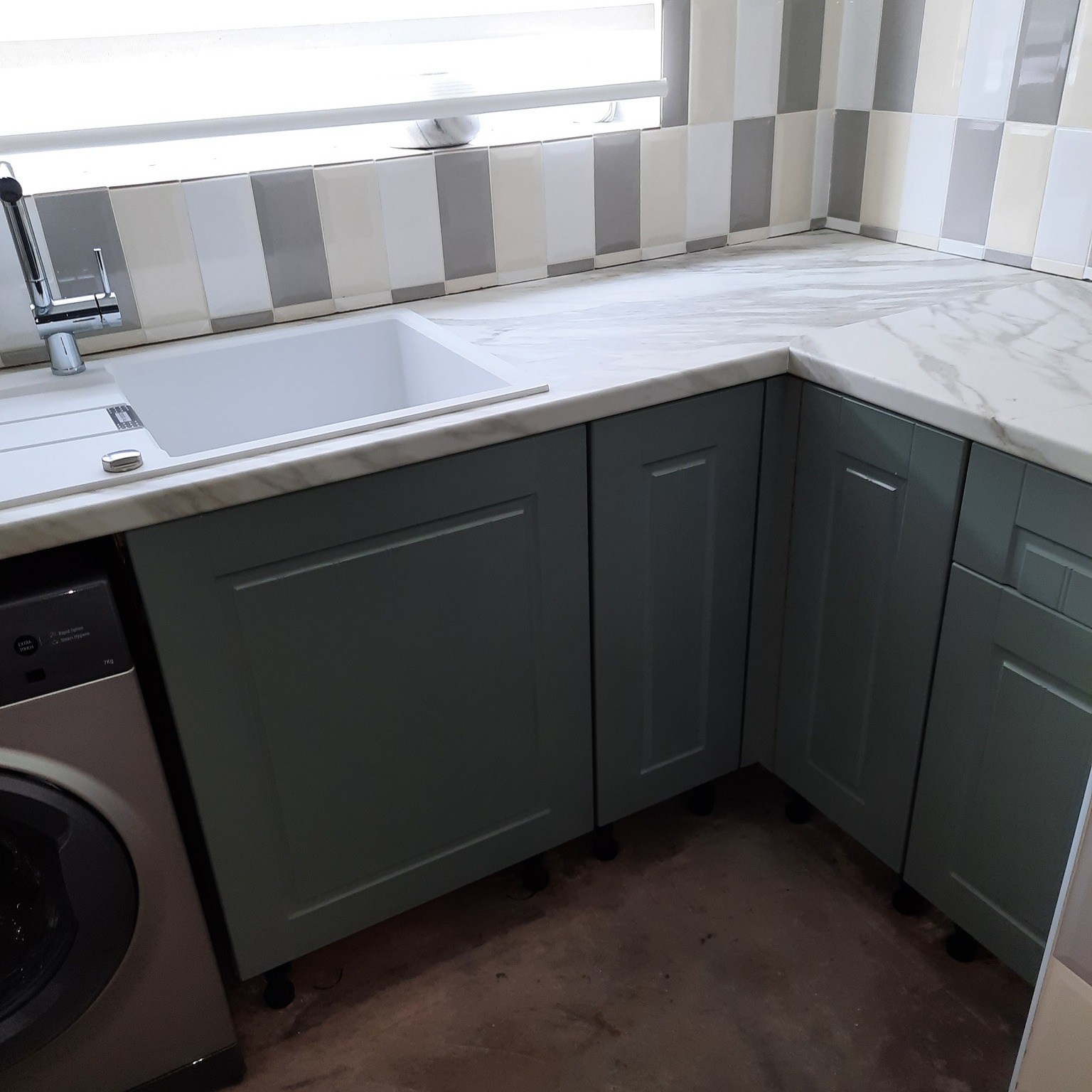 Real customer kitchen with matt sage green Newport kitchen doors in a classic shaker style design