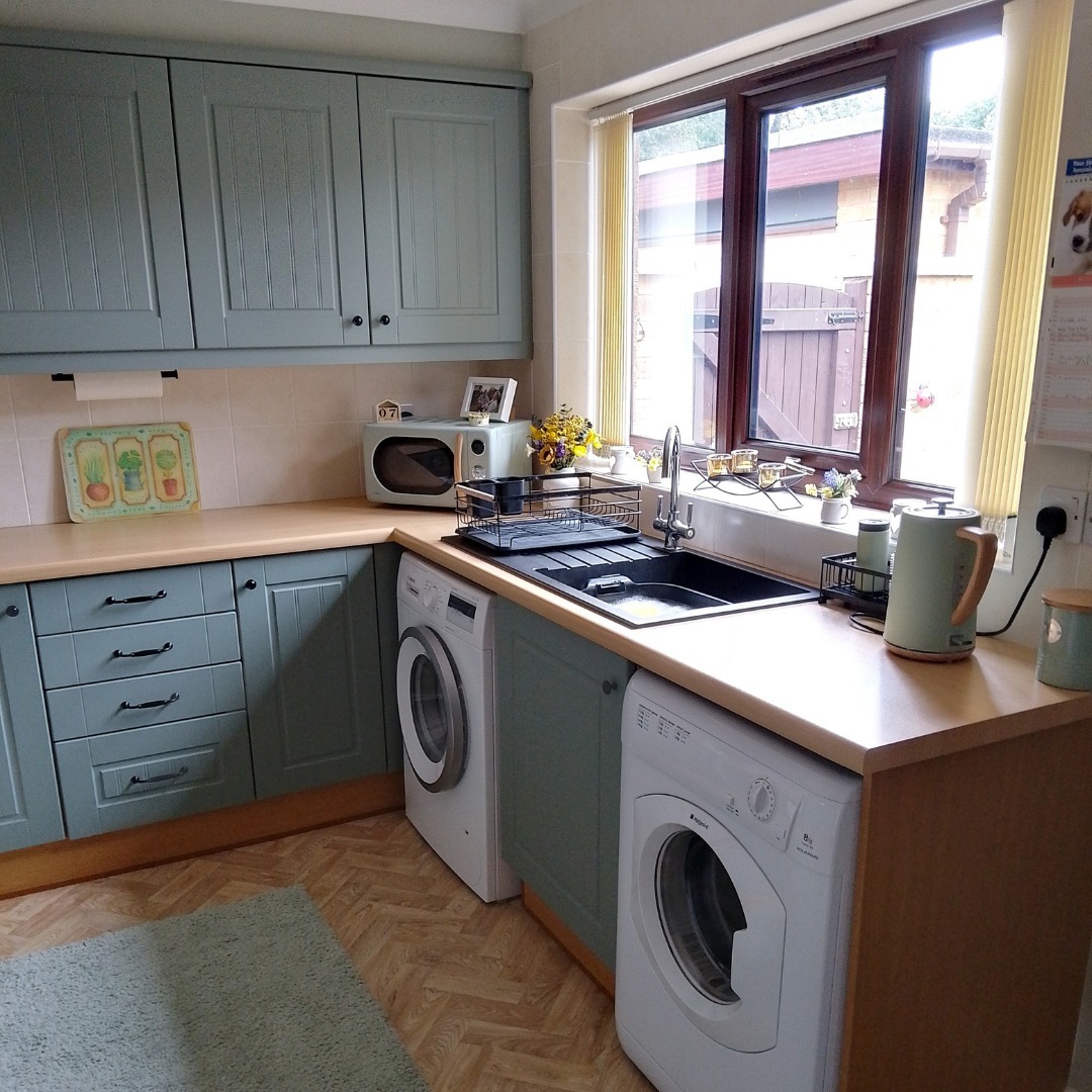 Customer kitchen with matt sage green Newport style kitchen doors in a soft muted finish