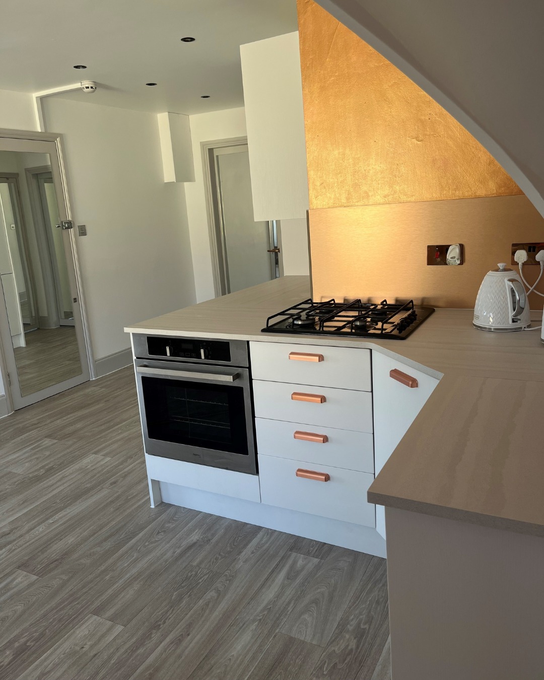 A Modern Kitchen Featuring Somerset Silk White Slab Doors