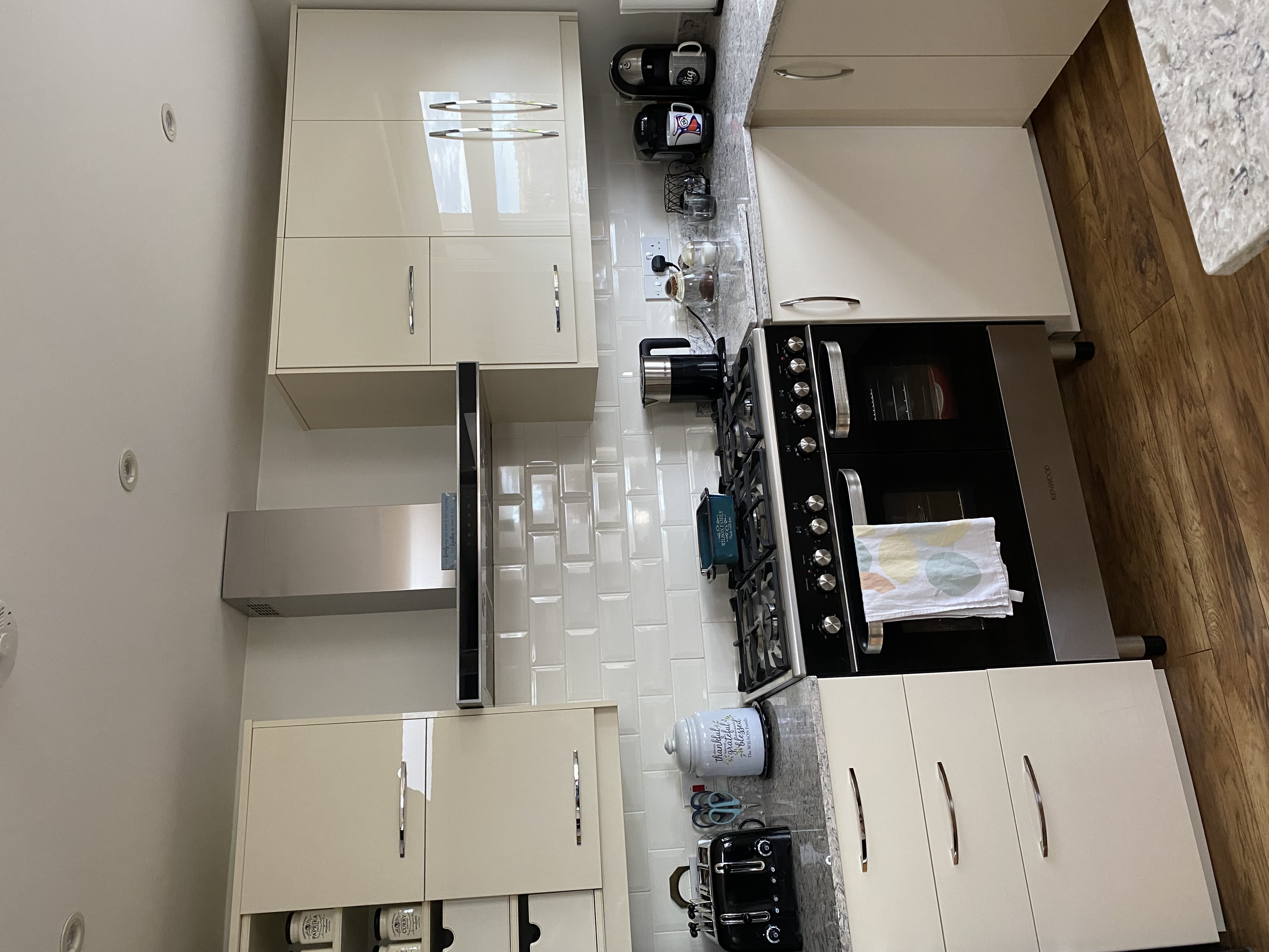 Real customer kitchen with Zurfiz ultragloss cream slab kitchen doors in a sleek modern design